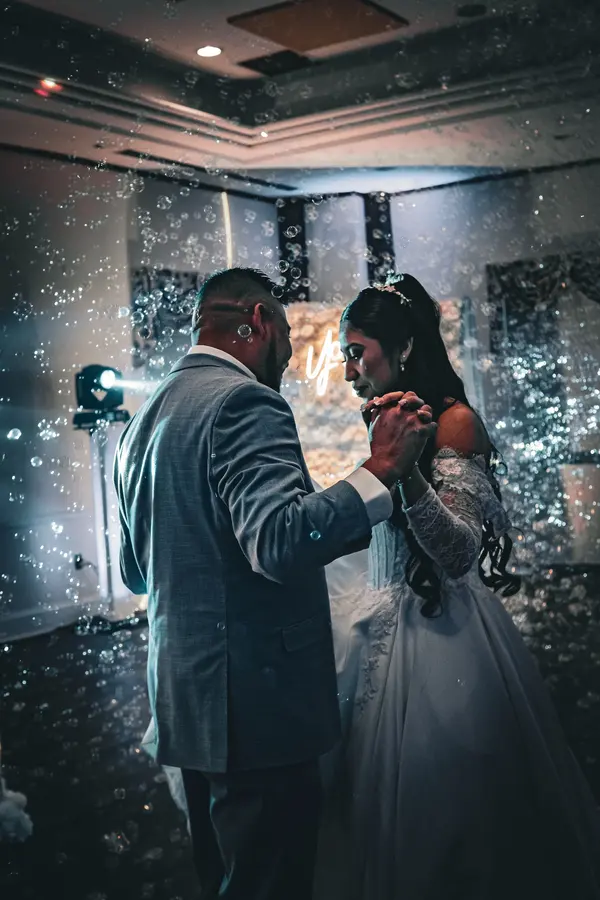 Bride and groom sharing their first dance under falling confetti